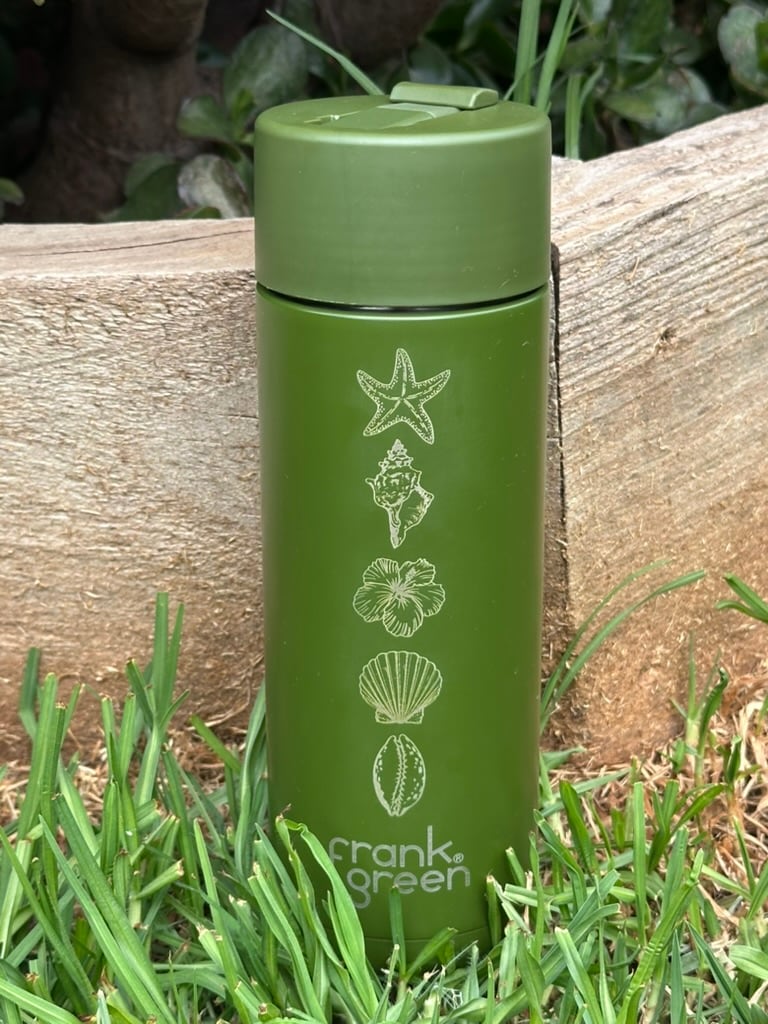 Green Frank Green bottle engraved with coastal shells and a starfish