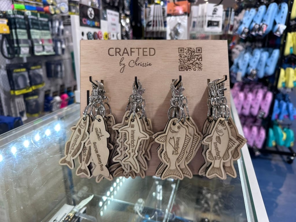 Fish-shaped Inverloch keytags on a branded shop display