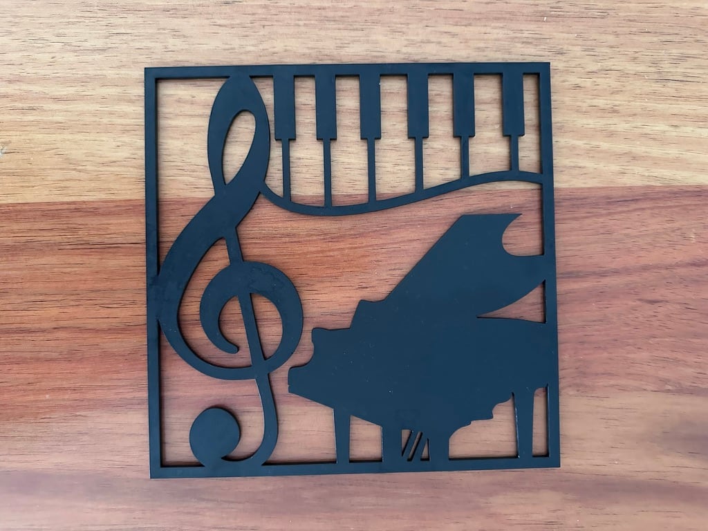Black laser-cut wall art featuring a piano, grand piano and treble clef