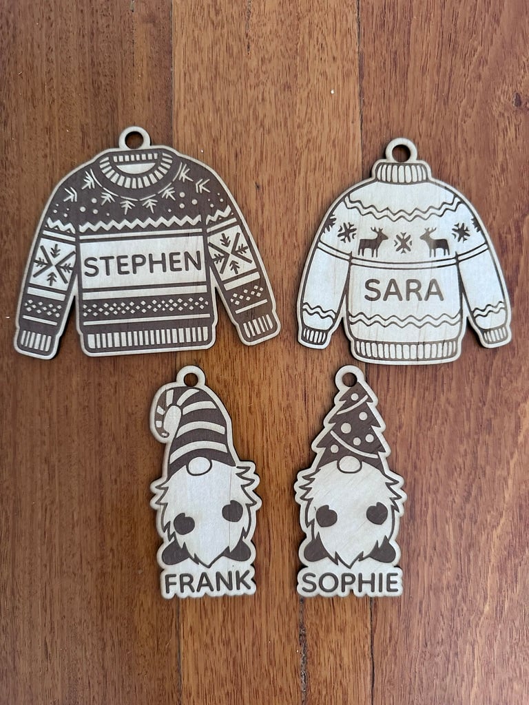 Four personalised wooden Christmas ornaments shaped as festive jumpers and gnomes